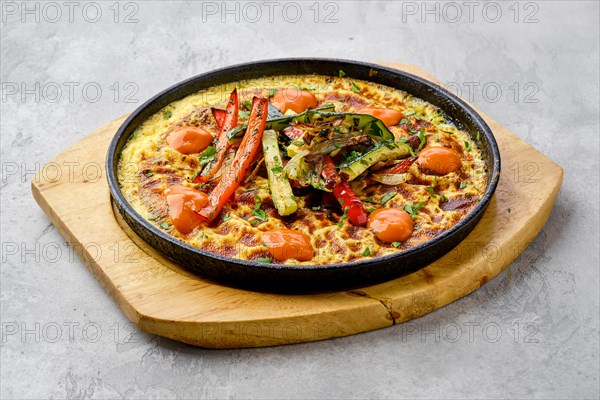 Eggs with bell pepper and zucchini baked in oven in cast-iron skillet