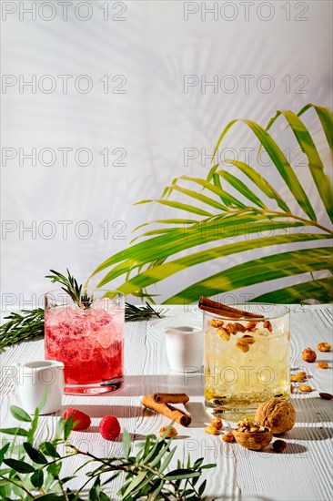 Refreshing espresso and tonic summer drinks on white table under hard sulight