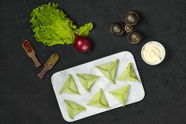 Overhead view of frozen dumplings with spinach