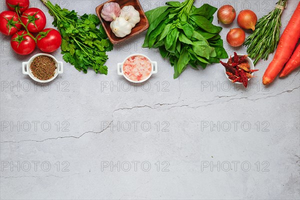 Food cooking and healthy eating concrete background with fresh seasoning and vegetables