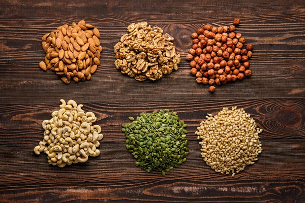 Assortment of nuts and seeds on wooden table