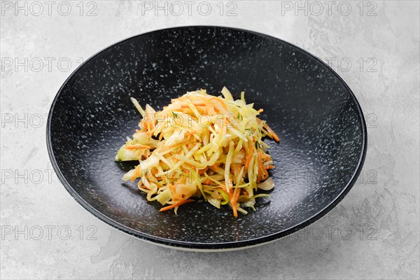 Pickled slices of cabbage and carrot on a plate
