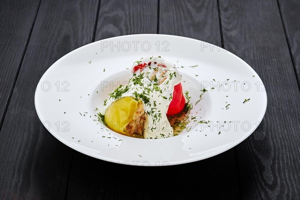 Bell pepper stuffed with minced meat on dark wooden table