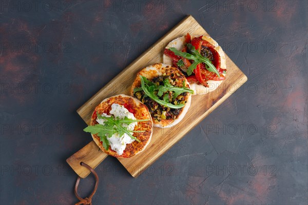 Top view of tapas platter on wooden plate