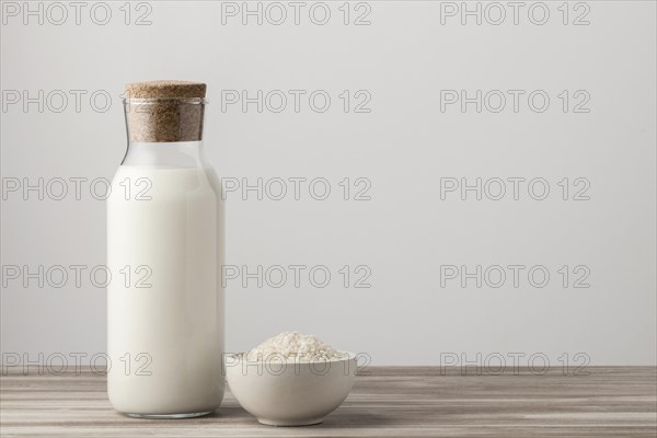 Front view milk bottle with rice copy space