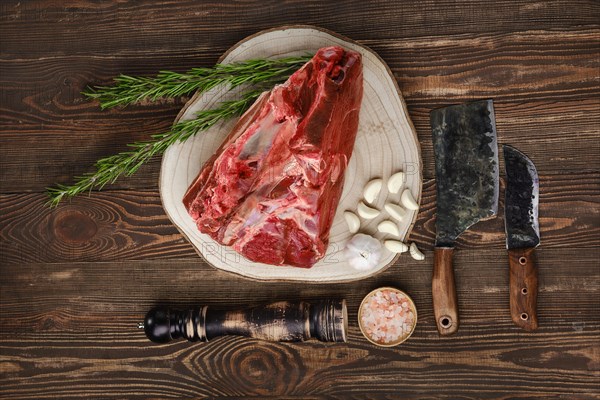 Raw fresh beef shank cross-cut on wooden background