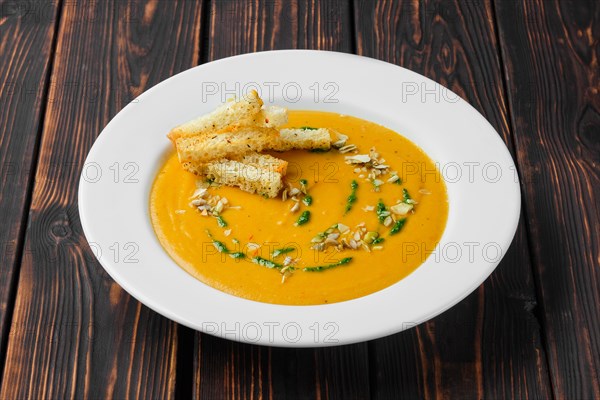Aubergine soup puree with pumpkin seed and crouton