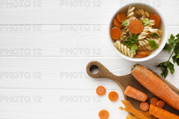 Flat lay fusilli broccoli carrots bowl with copy space