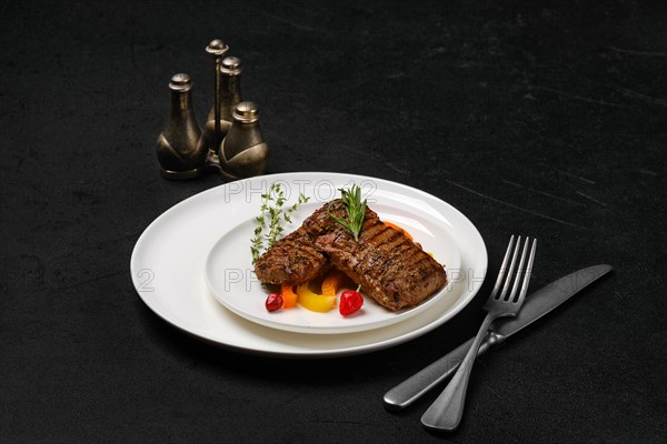 Two grilled steaks on a plate