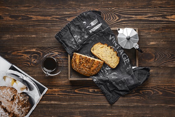 Fresh oats bread with sunflower seeds and sesame on wooden table