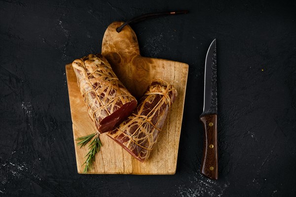 Top view of smoked beef striploin meat on cutting board