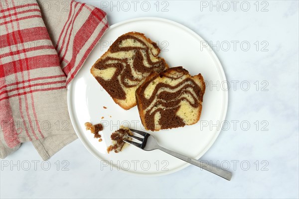 Two pieces of marble cake on plate