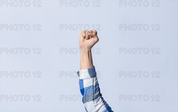 Hand gesturing the letter S in sign language on an isolated background. Man's hand gesturing the letter S of the alphabet isolated. Letter S of the alphabet in sign language