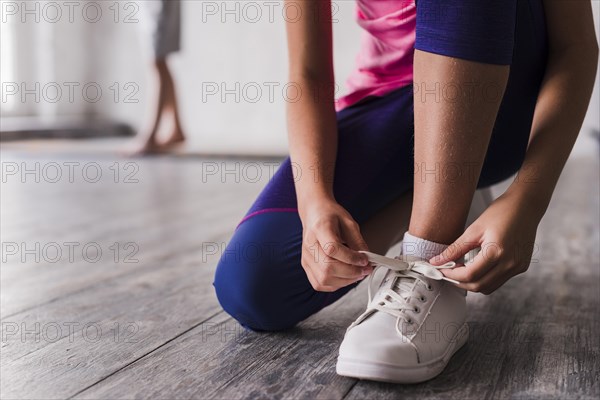 Low section girl tying shoelace white shoes. Resolution and high quality beautiful photo