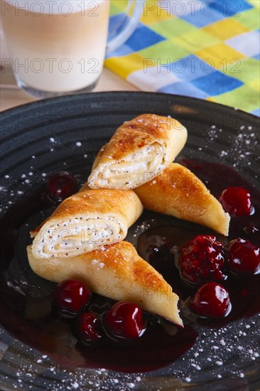 Thin pancakes with curd and cherry jam