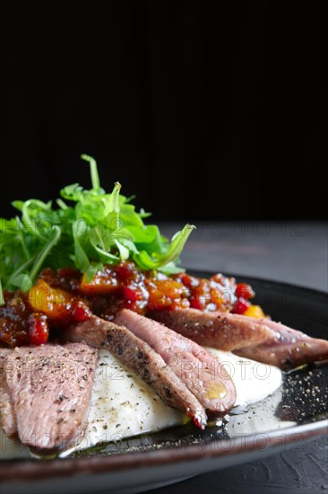 Roasted beef with caramelized vegetables and arugula