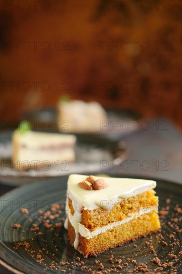 Three pieces of homemade cakes on a dark wooden vintage background