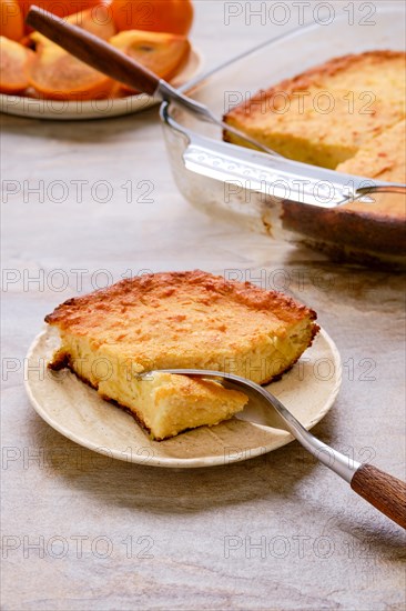 Persimmon pie and fresh fruits on wooden table