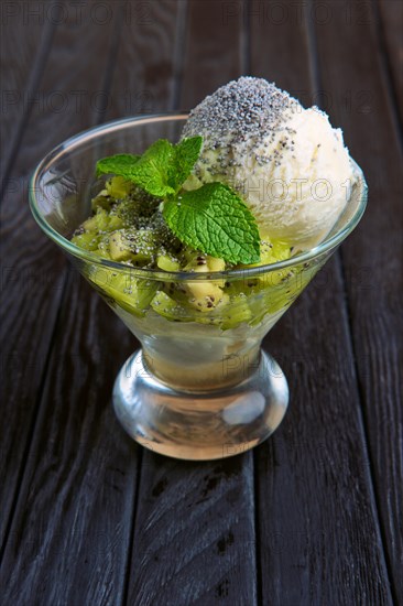 A cup of apple ice cream decorated with kiwi