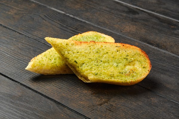Two pieces of garlic bread on a table