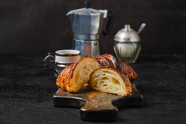 Classic breakfast with croissant cut on half and espresso coffee