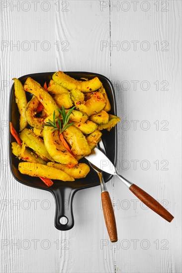 Top view of spicy pumpkin and carrot baked in oven on ceramic plate