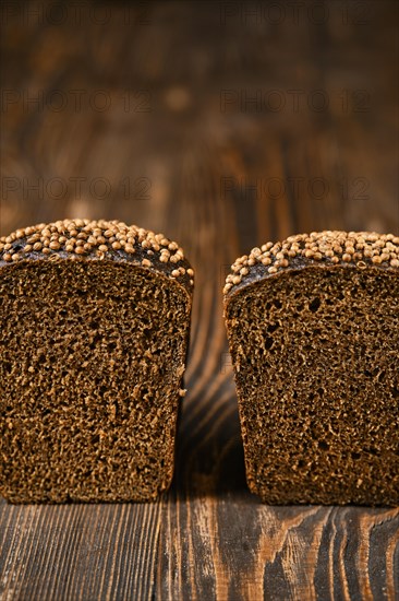 Closeup view of fresh rye brown bread on wooden cutting board