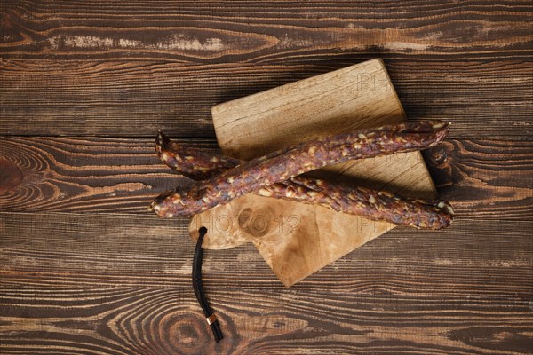 Sun dried turkey sausages on wooden background