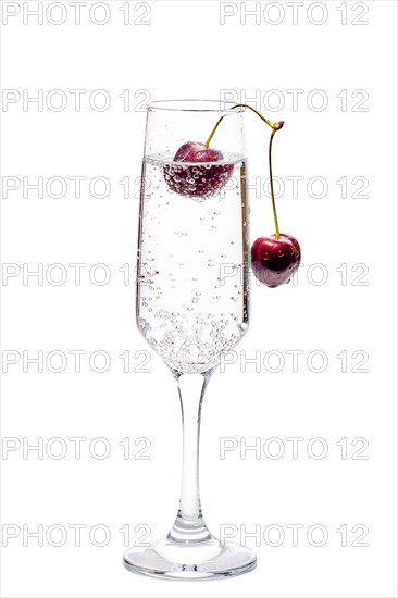 Gin and tonic with cherry isolated on white background