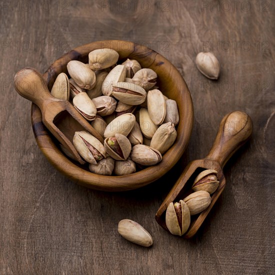 Roasted pistachio nuts wooden bowls