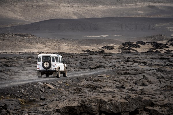 White Land Rover on a dirt road