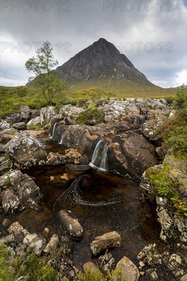 Waterfalls in front of mountain range Buachaille Etive Mor