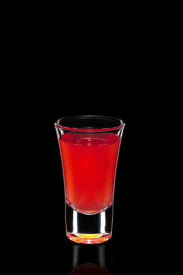 Fresh cranberry juice as ingredient for vodka cocktail isolated on black
