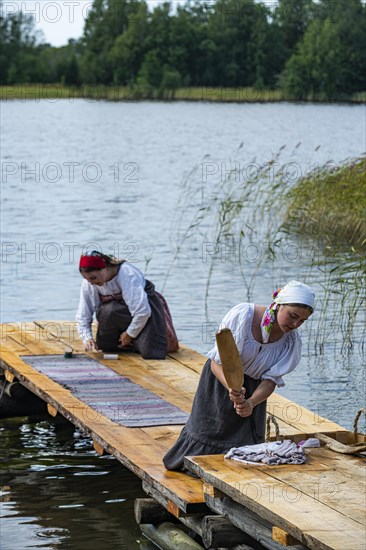 Traditionla dressed women doing hand washing