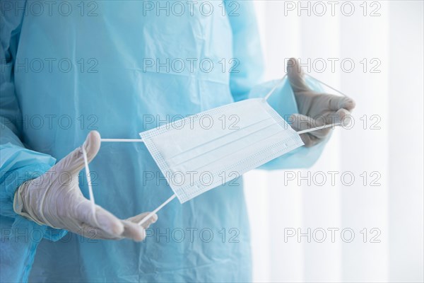 Doctor holding medical mask