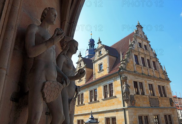 The figures of Adam and Eve on the main portal of the church of St. Moritz and the building of the Casimirianum grammar school