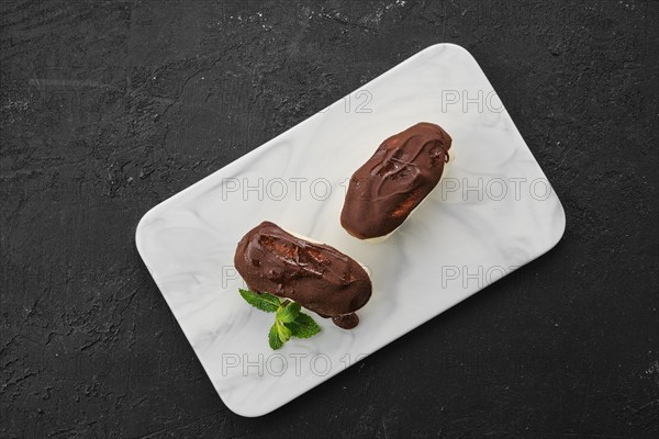 Top view of glazed curd with chocolate on marble plate