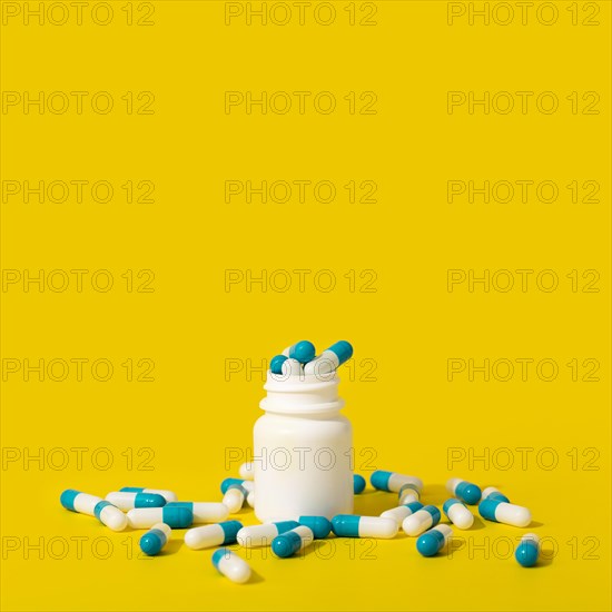 Front view of container with pills and copy space