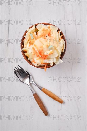 Overhead view of clay bowl with homemade pickled cabbage