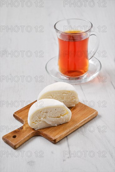 Sweet dessert mochi with coconut chips cut on half with fruit tea