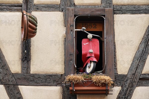 Decorated window on a half-timbered house in the historic old town of Riquewihr