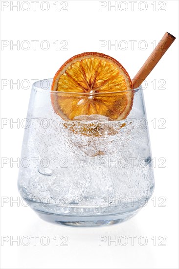 Glass of spicy tonic with ice isolated on white