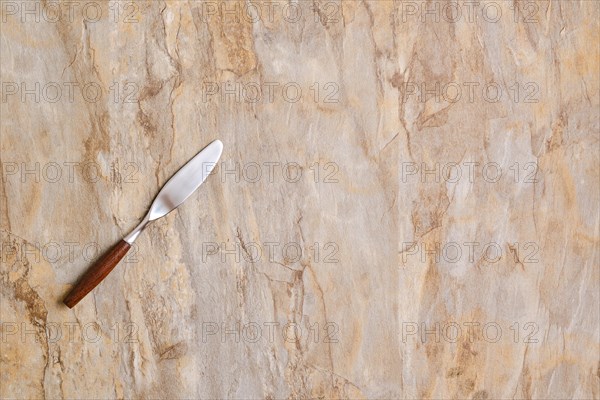 Spreading knife on empty wooden surface