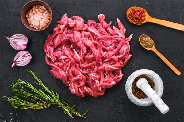 Top view of raw duck breast on black concrete background