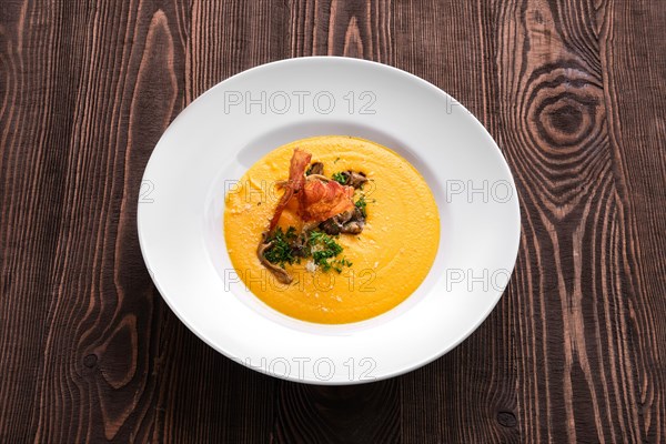 Mashed pumpkin soup puree with bacon