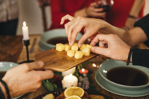 Friends eating cheese christmas