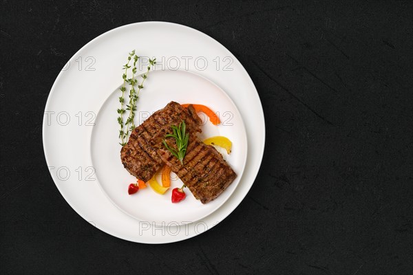 Top view of two grilled steaks on a plate