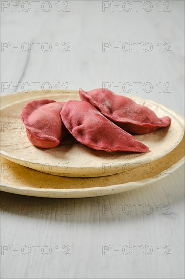 Concept of delivery of semifinished food. Sweet dumplings stuffed with cherry and frozen