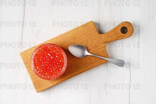 Overhead view of open pot with pink salmon red caviar