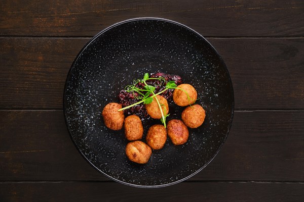 Plate with traditional scandinavian meatballs with cranberry sauce